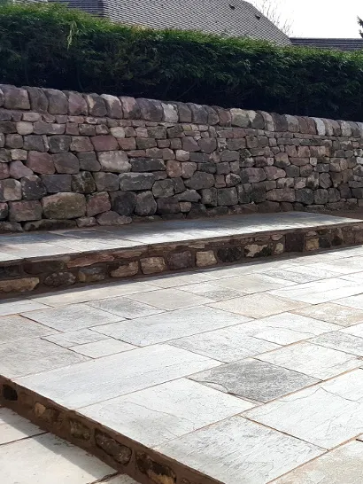 A stepped patio made with stone paving.